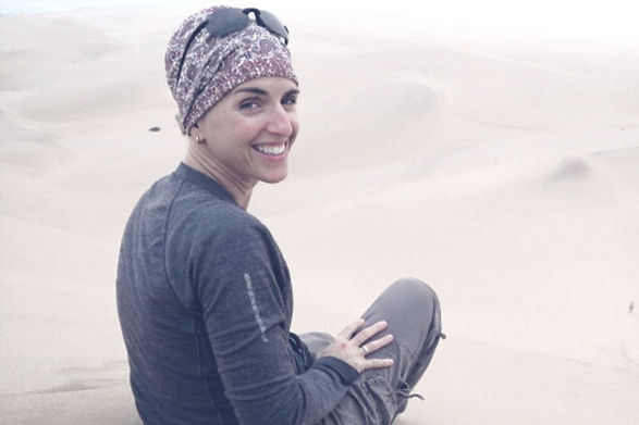 Karin Schwindack nutritionist sitting on top of sand dunes
