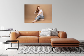big wall portrait of a young woman above a sofa