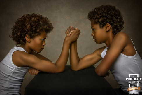 Fine Art Portrait of 2 young boys arm wrestling