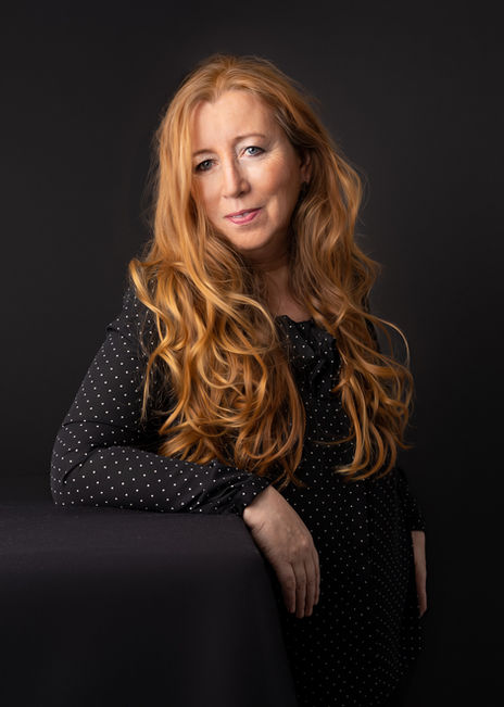 Portrait of woman with long red hair