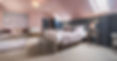 Cosy bedroom with large bed, sofa and ensuite.