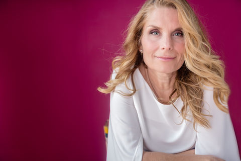 Woman in white blouse on fuchsia backdrop