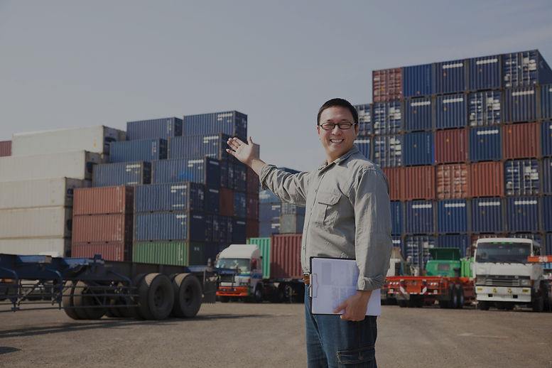 Smiling Person Standing In Front Of Container Yard_edited.jpg