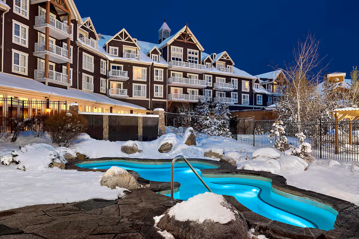 Exterior of The Westin Trillium House, Blue Mountain, featuring grand lodge‑style architecture with stone and timber accents, overlooking Mill Pond in Blue Mountain Village.
