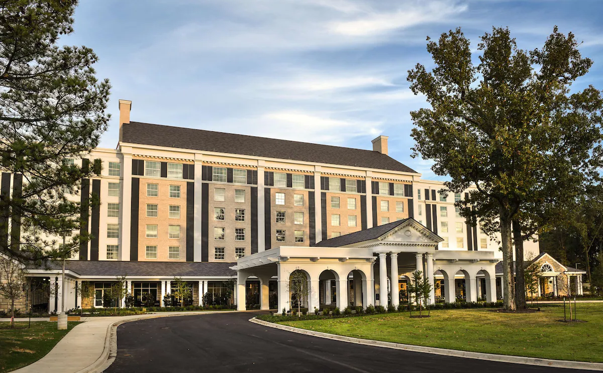 Exterior of The Guest House at Graceland in Memphis, Tennessee, a Southern‑colonial style luxury hotel with white columns, grand entrance, and architecture inspired by Elvis Presley’s Graceland Mansion.
