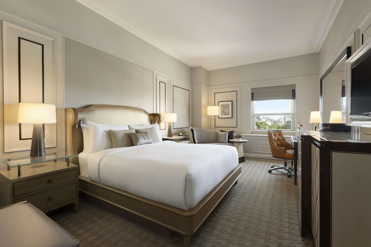 Guest room at Fairmont Le Château Frontenac in Quebec City featuring elegant décor, plush bedding, and large windows with views of Old Quebec or the St. Lawrence River.