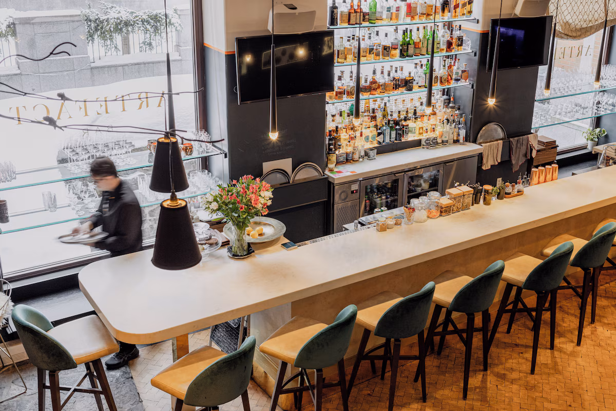 Dining at Auberge Saint-Antoine in Quebec City, featuring Chez Muffy restaurant with farm‑to‑fork French Canadian cuisine, rustic‑chic décor, and views of the St. Lawrence River.