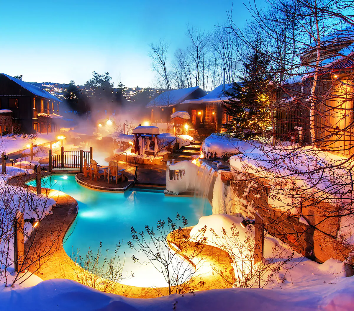 Georgian Bay Hotel, Trademark Collection by Wyndham, outdoor pool in winter surrounded by snow, with steam rising from the heated water against a frosty backdrop.