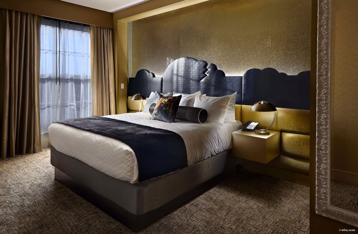 Guest room at The Guest House at Graceland in Memphis, Tennessee, featuring Southern‑inspired décor, plush bedding, custom headboard, and modern amenities reflecting Elvis Presley’s signature style.