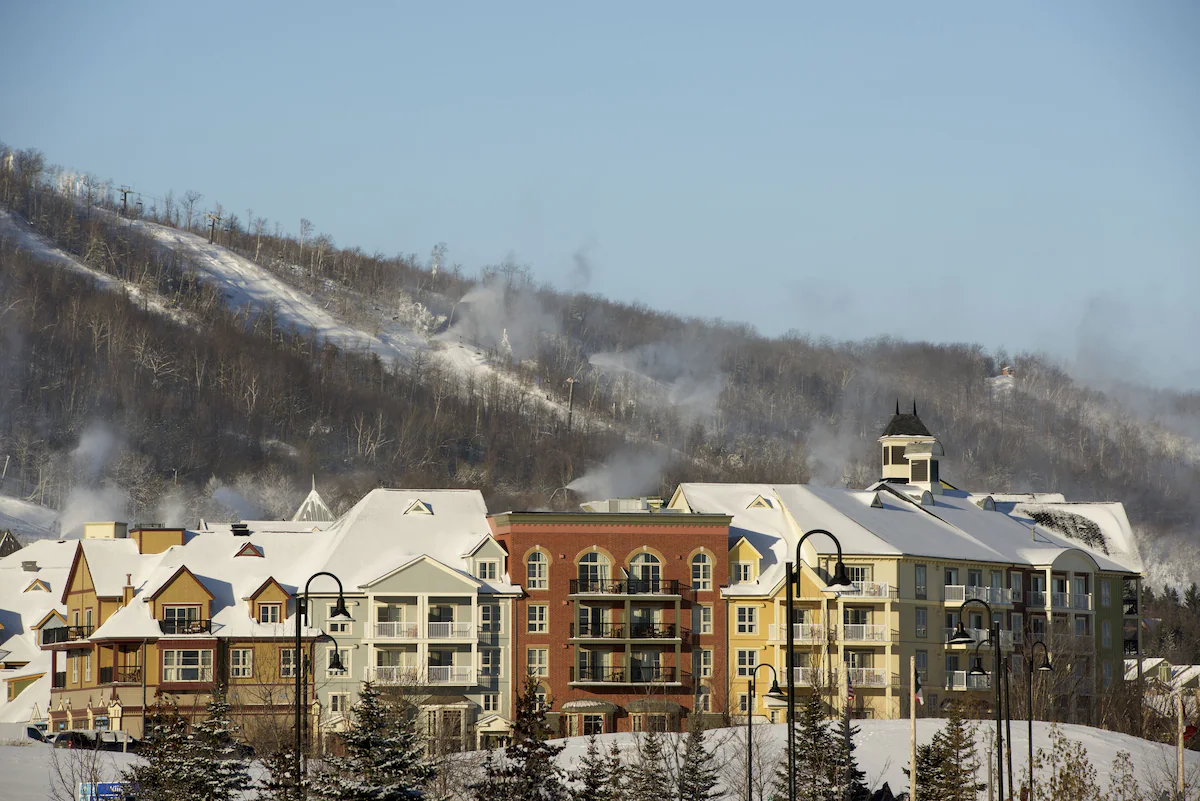 Exterior of Mosaic – Boutique Suites by Blue Mountain Resorts, featuring modern boutique architecture with stone and wood accents, located in Blue Mountain Village.
