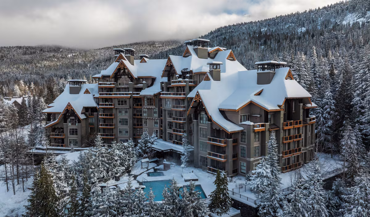 Exterior of Four Seasons Resort and Residences Whistler, a luxury alpine lodge with timber and stone architecture, nestled at the base of Whistler Blackcomb in British Columbia."