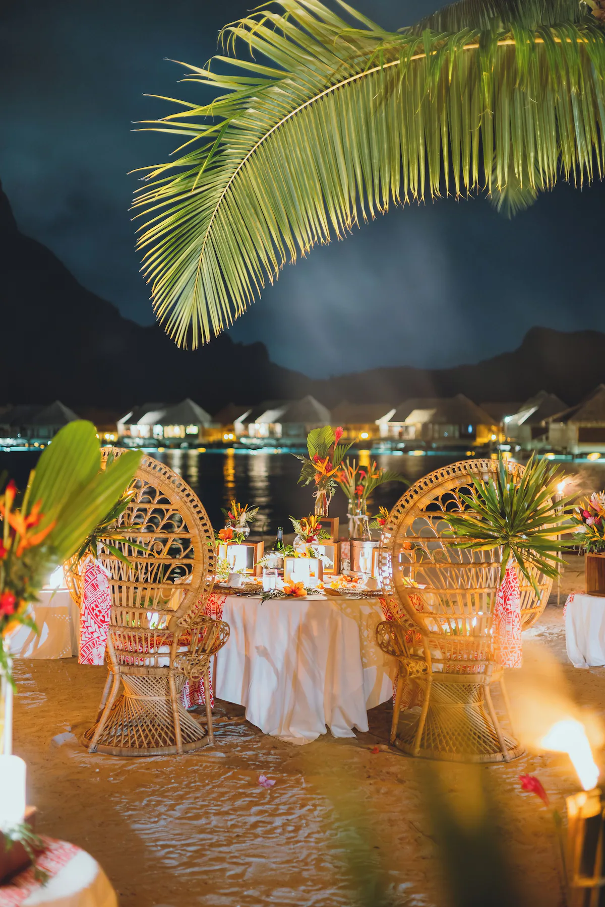 Dining at InterContinental Le Moana Bora Bora Resort with open‑air seating, Polynesian décor, and views of the turquoise lagoon and white‑sand beach.