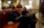 Guests enjoying the fireplace in the lounge of the Redwood Hotel & Casino.