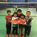 kids at a badminton summer camp with a badminton coach having fun