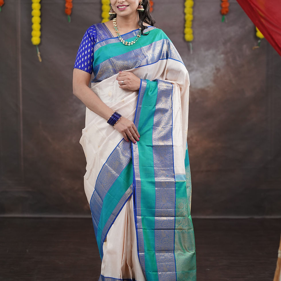 Woman in light pink and blue saree with green border