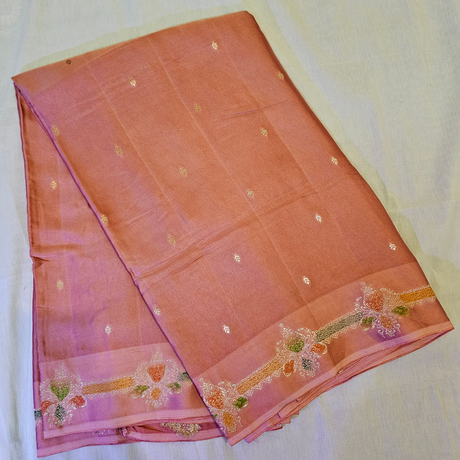 Folded pastel nude Mashru Mena silk fabric with motifs.