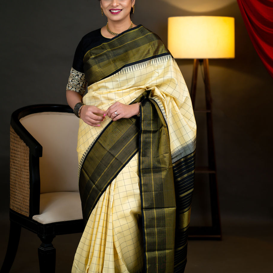 Woman posing in A20- Cream and Black Saree