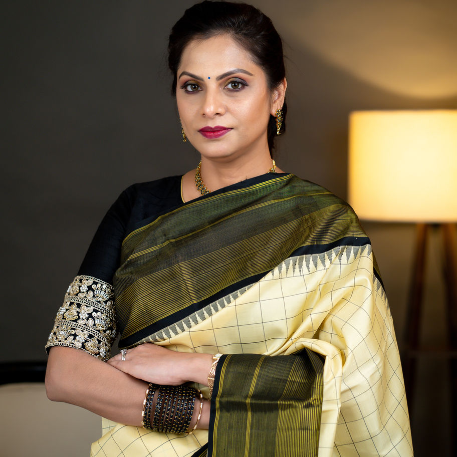 Woman wearing the A20 cream and black saree