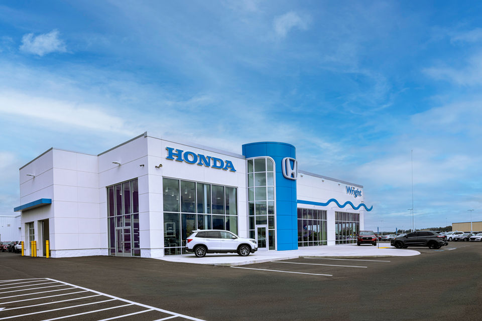 Honda dealership building with a white SUV