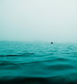 solitary-boat-adrift-in-vast-ocean.jpg