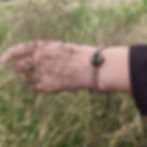 Handmade silk braided bracelet with genuine Baltic amber worn on the wrist.