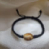 Adjustable black natural silk bracelet with genuine Baltic amber
