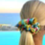 Handmade natural silk scrunchie in multicolor floral pattern worn in blonde hair