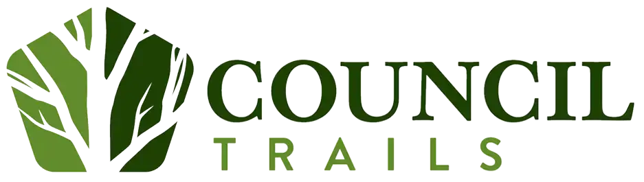 Council Trails Apartments logo with green leaves and text.