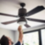 Electrician hanging celing fan