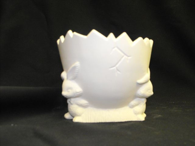 Three Rabbits Holding Cracked Egg