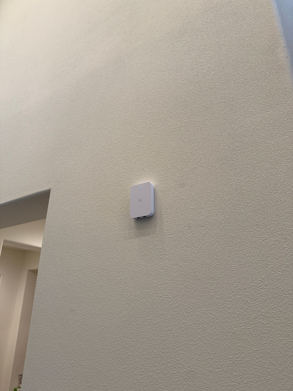 Organized network panel and Ubiquiti access points installed throughout a Blackhawk home