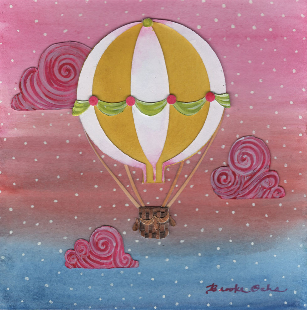 Yellow and white balloon in front of pink clouds