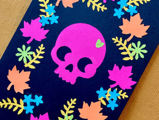 Fluorescent pink skull and flowers and leaves pasted on a black background 