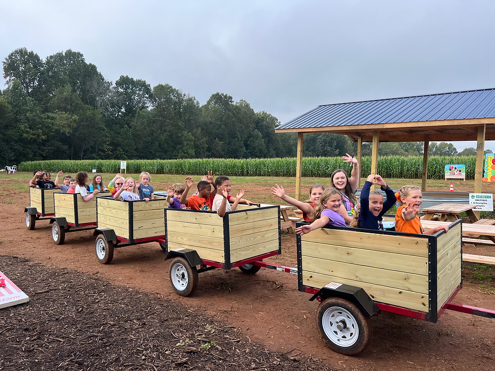 Children riding a barrel train at Stas Farm.