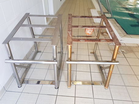 Two stainless steel pool ladder frames side by side indoors: one shiny new, one rusty and old, on beige tiles beside turquoise water.