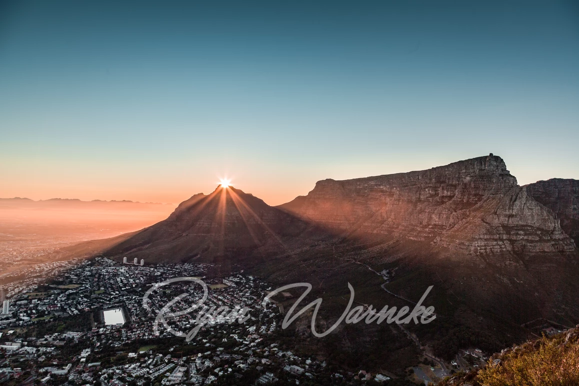 Table Mountain sunrise with the sun peaking over Devils Peak in Cape Town South Africa
