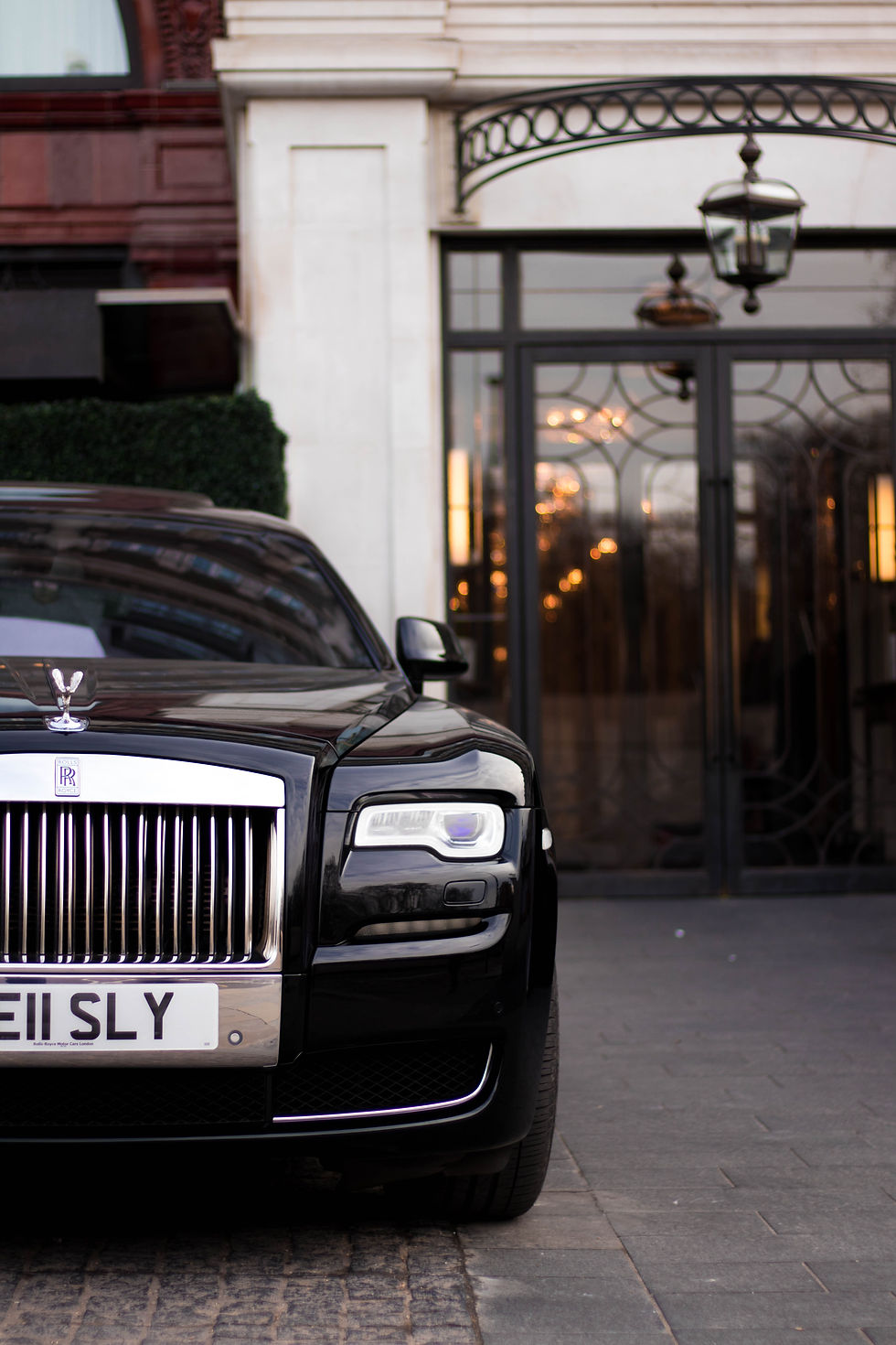 luxury car in front of hotel