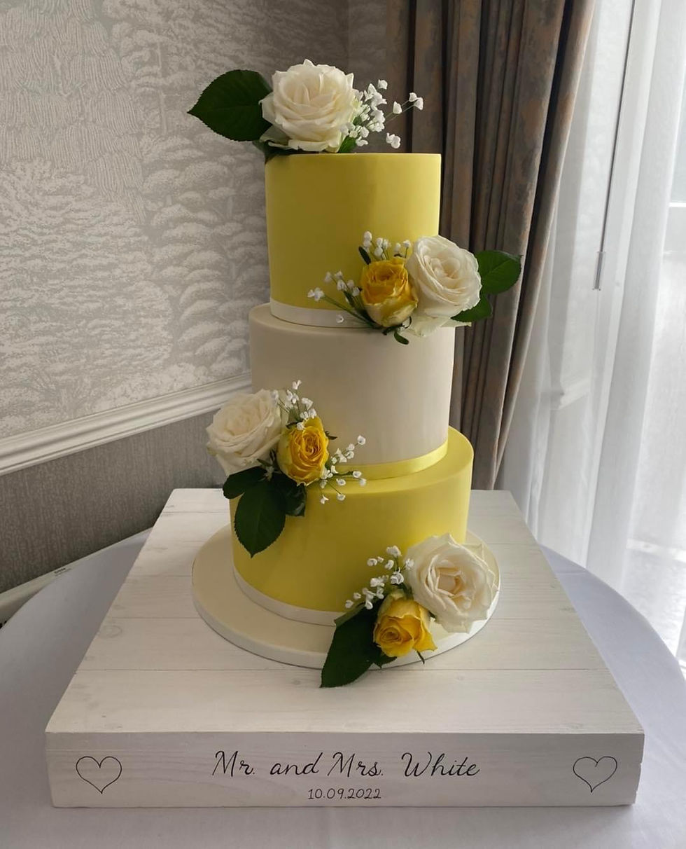 Yellow wedding cake with fresh yellow and white roses and sugar gypsophila by Cakes of Curiosity
