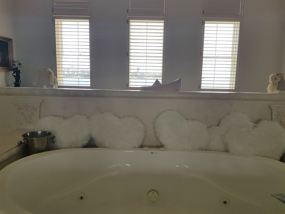 Behind the bed the spa bath lies 