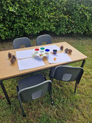 A small table and chair with painting supplies