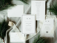 Wedding invitations with pine branches and ribbon