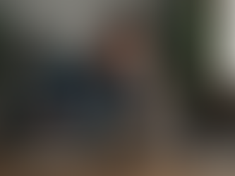 Middle-aged man sitting at a desk in a home office, rubbing his eyes with a fatigued expression while looking at a laptop, with a notebook and coffee mug nearby—illustrating mental fatigue and lack of restorative sleep.