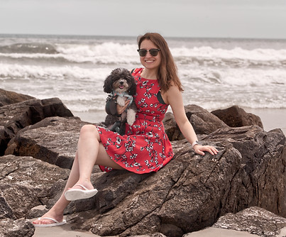 Model Sitting on a Rock at Ocean Coast