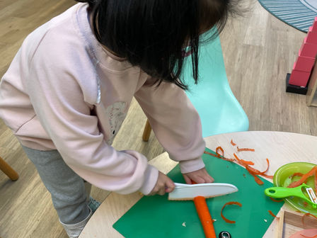 A Day in the Life of a Casa Montessori Student - Preparing a snack for the class in the Practical Life area of the classroom at Treetops Montessori Preschool