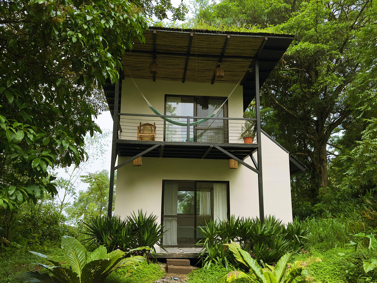 Nahuali cabin with a hammock on its forest-facing balcony