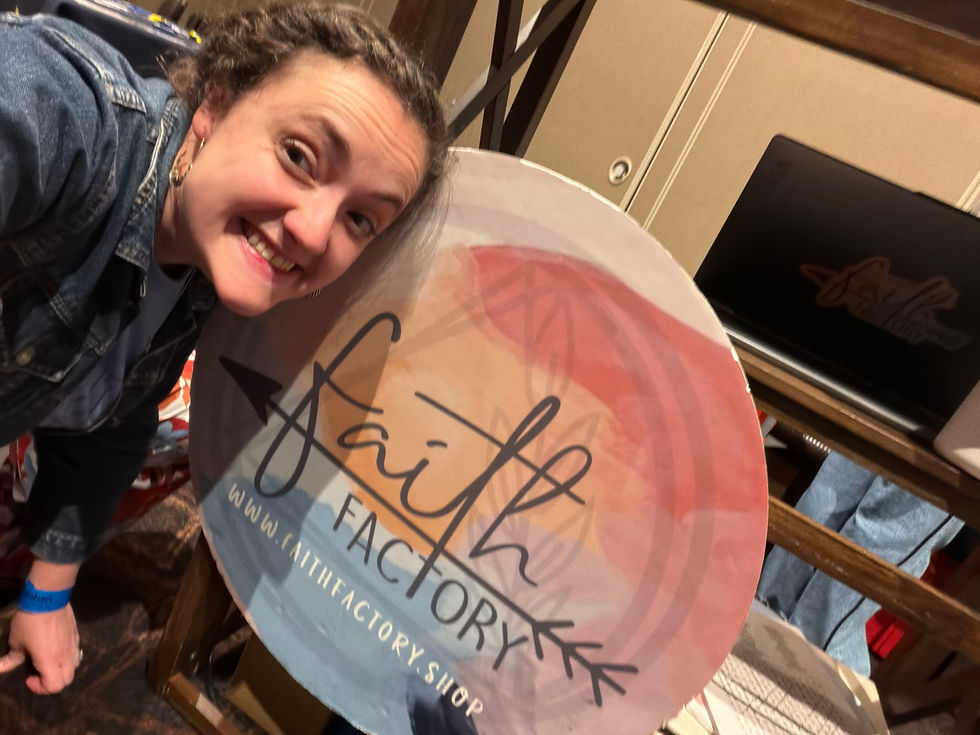 faith factory team member with the company logo and sign