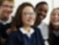 Uniform school pupils laughing. Participating in a laughter therapy activity for students.