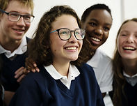 Uniform school pupils laughing. Participating in a laughter therapy activity for students.