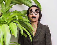Businesswomen being silly and having fun at work, wearing funny glasses.