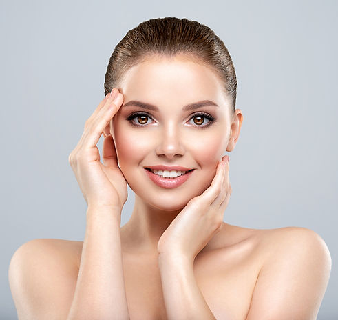 A model touching her temples, illustrating how biostimulators like Sculptra and Radiesse provide a natural lift by regenerating collagen